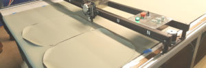 CNC machine cutting vinyl during reupholstery process in grand rapids mi